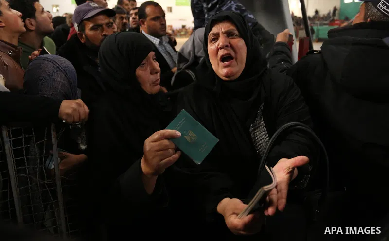 Palestinians wait for travel permits to cross into Egypt through the Rafah border crossing after it was opened by Egyptian authorities for humanitarian cases on the first time in 2018, in the southern Gaza Strip on Febru...
