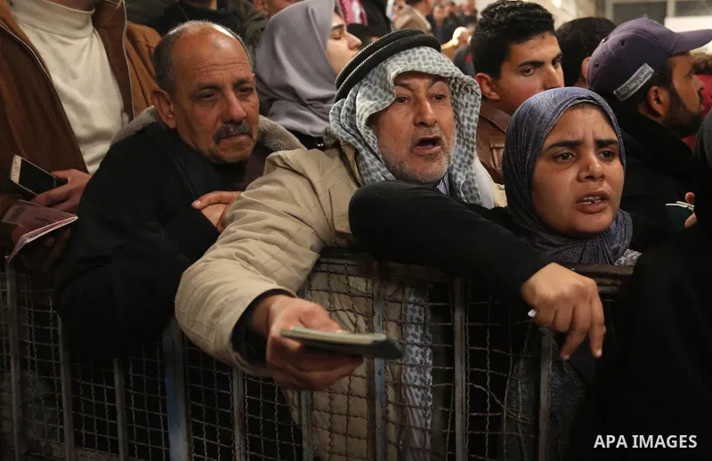 Palestinians wait for travel permits to cross into Egypt through the Rafah border crossing after it was opened by Egyptian authorities for humanitarian cases on the first time in 2018, in the southern Gaza Strip on Febru...