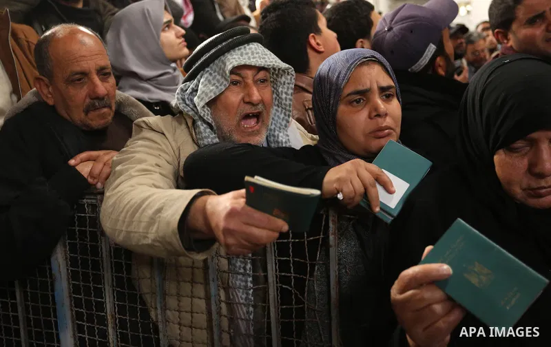 Palestinians wait for travel permits to cross into Egypt through the Rafah border crossing after it was opened by Egyptian authorities for humanitarian cases on the first time in 2018, in the southern Gaza Strip on Febru...