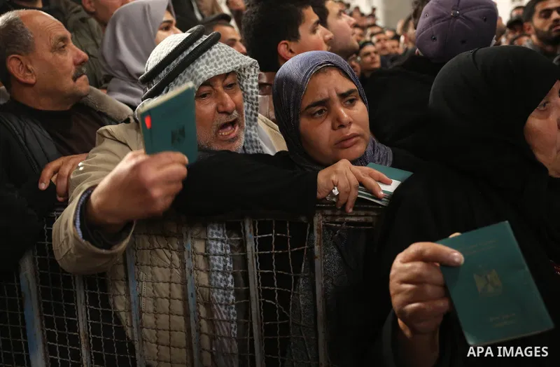 Palestinians wait for travel permits to cross into Egypt through the Rafah border crossing after it was opened by Egyptian authorities for humanitarian cases on the first time in 2018, in the southern Gaza Strip on Febru...