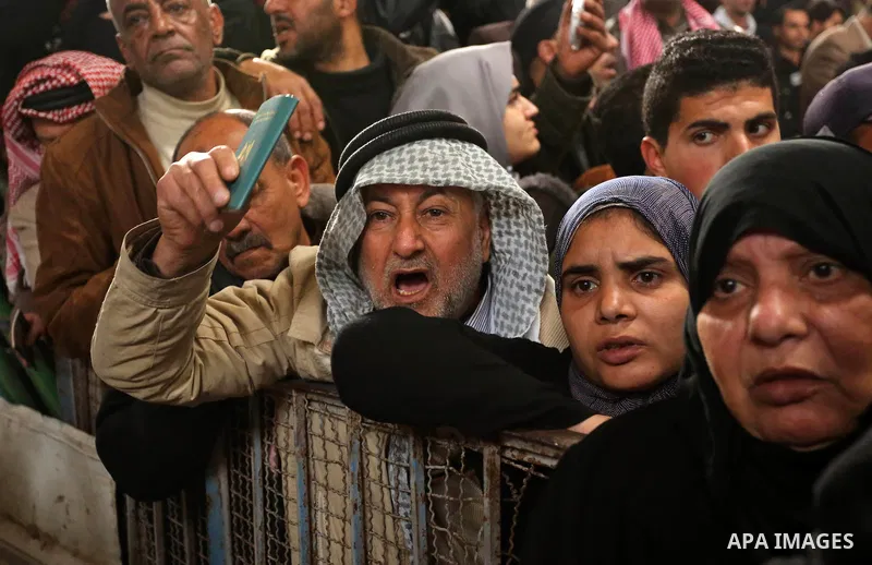 Palestinians wait for travel permits to cross into Egypt through the Rafah border crossing after it was opened by Egyptian authorities for humanitarian cases on the first time in 2018, in the southern Gaza Strip on Febru...