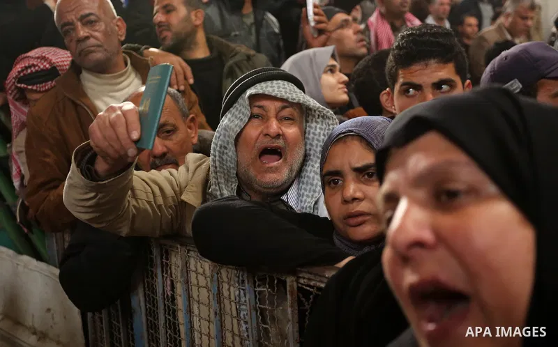 Palestinians wait for travel permits to cross into Egypt through the Rafah border crossing after it was opened by Egyptian authorities for humanitarian cases on the first time in 2018, in the southern Gaza Strip on Febru...
