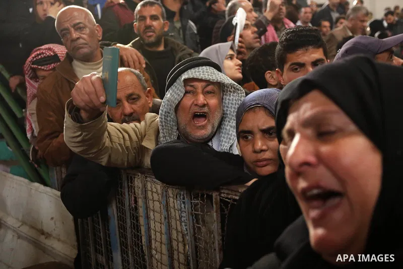 Palestinians wait for travel permits to cross into Egypt through the Rafah border crossing after it was opened by Egyptian authorities for humanitarian cases on the first time in 2018, in the southern Gaza Strip on Febru...