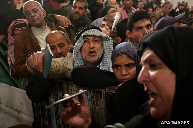 Palestinians wait for travel permits to cross into Egypt through the Rafah border crossing after it was opened by Egyptian authorities for humanitarian cases on the first time in 2018, in the southern Gaza Strip on Febru...