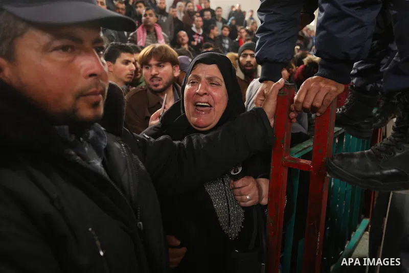 Palestinians wait for travel permits to cross into Egypt through the Rafah border crossing after it was opened by Egyptian authorities for humanitarian cases on the first time in 2018, in the southern Gaza Strip on Febru...