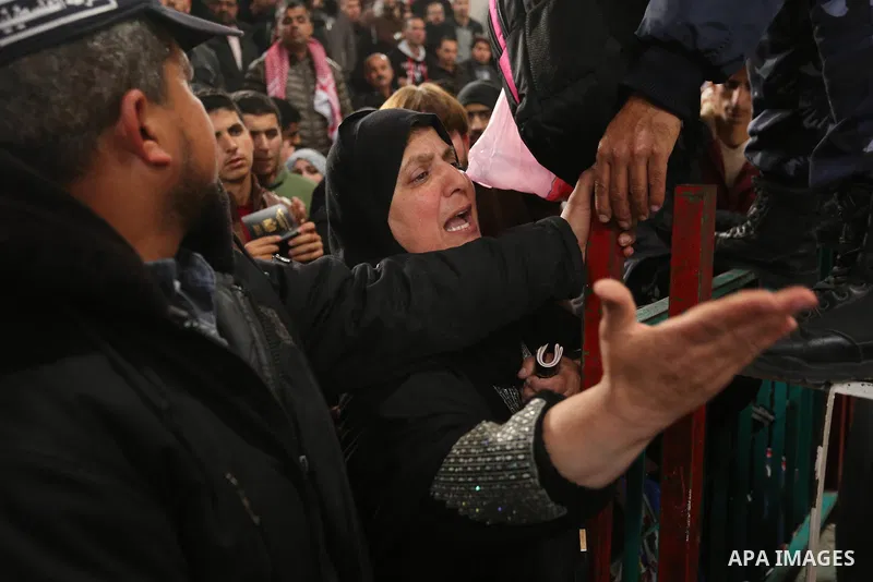 Palestinians wait for travel permits to cross into Egypt through the Rafah border crossing after it was opened by Egyptian authorities for humanitarian cases on the first time in 2018, in the southern Gaza Strip on Febru...