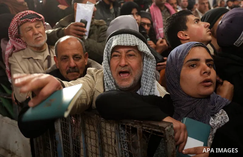 Palestinians wait for travel permits to cross into Egypt through the Rafah border crossing after it was opened by Egyptian authorities for humanitarian cases on the first time in 2018, in the southern Gaza Strip on Febru...