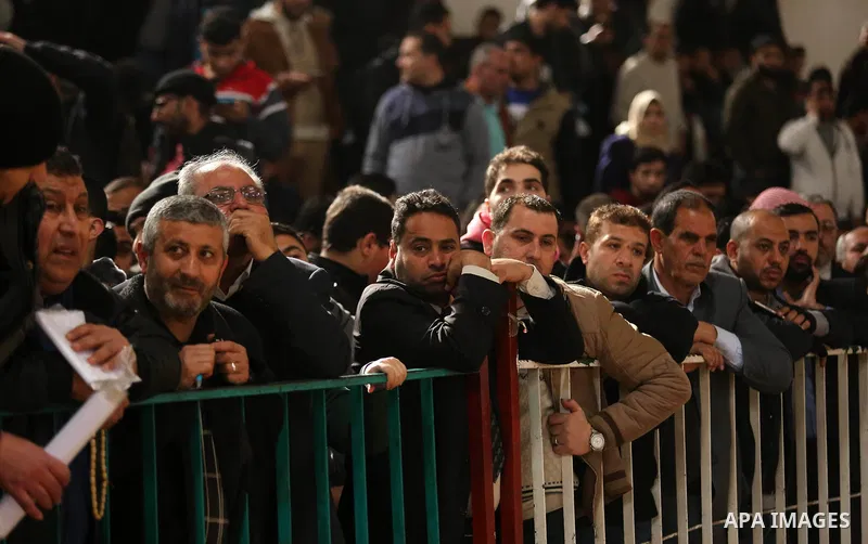 Palestinians wait for travel permits to cross into Egypt through the Rafah border crossing after it was opened by Egyptian authorities for humanitarian cases on the first time in 2018, in the southern Gaza Strip on Febru...