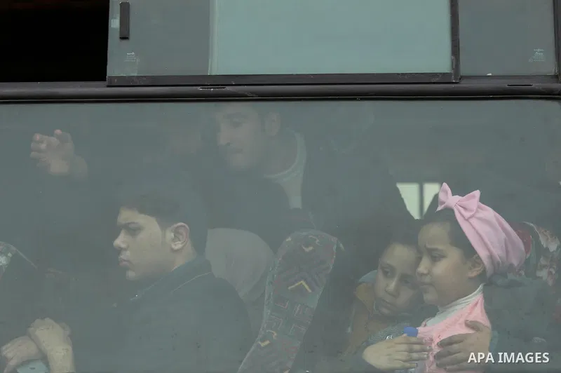 Palestinians wait for travel permits to cross into Egypt through the Rafah border crossing after it was opened by Egyptian authorities for humanitarian cases on the first time in 2018, in the southern Gaza Strip on Febru...