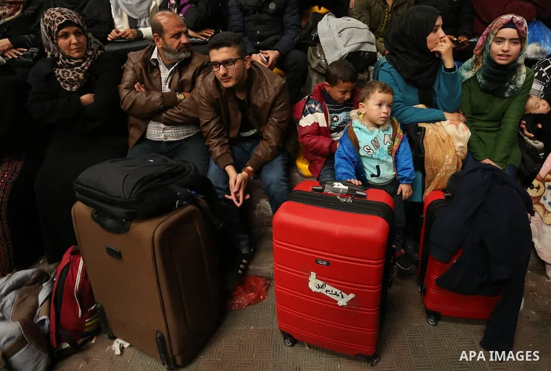 Palestinians wait for travel permits to cross into Egypt through the Rafah border crossing after it was opened by Egyptian authorities for humanitarian cases on the first time in 2018, in the southern Gaza Strip on Febru...