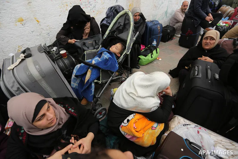 Palestinians wait for travel permits to cross into Egypt through the Rafah border crossing after it was opened by Egyptian authorities for humanitarian cases on the first time in 2018, in the southern Gaza Strip on Febru...