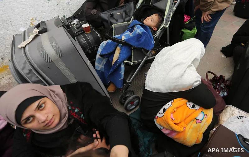 Palestinians wait for travel permits to cross into Egypt through the Rafah border crossing after it was opened by Egyptian authorities for humanitarian cases on the first time in 2018, in the southern Gaza Strip on Febru...
