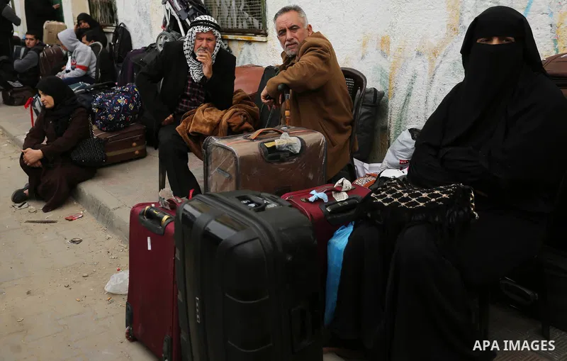 Palestinians wait for travel permits to cross into Egypt through the Rafah border crossing after it was opened by Egyptian authorities for humanitarian cases on the first time in 2018, in the southern Gaza Strip on Febru...