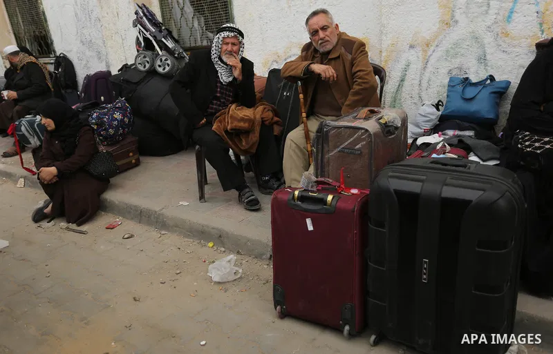 Palestinians wait for travel permits to cross into Egypt through the Rafah border crossing after it was opened by Egyptian authorities for humanitarian cases on the first time in 2018, in the southern Gaza Strip on Febru...