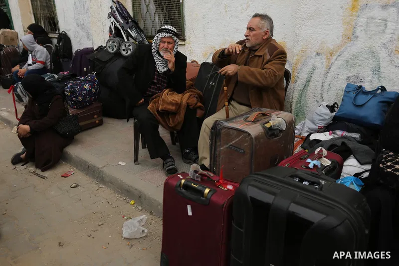 Palestinians wait for travel permits to cross into Egypt through the Rafah border crossing after it was opened by Egyptian authorities for humanitarian cases on the first time in 2018, in the southern Gaza Strip on Febru...