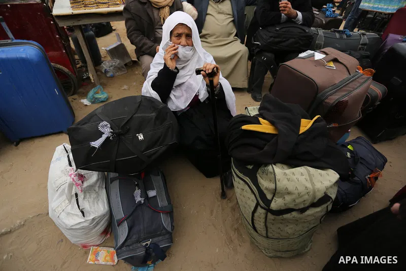 Palestinians wait for travel permits to cross into Egypt through the Rafah border crossing after it was opened by Egyptian authorities for humanitarian cases on the first time in 2018, in the southern Gaza Strip on Febru...
