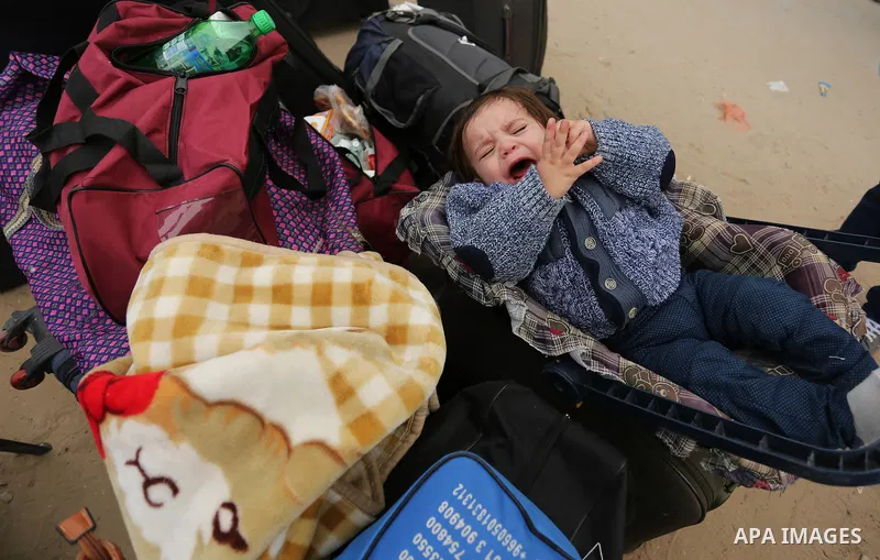 Palestinians wait for travel permits to cross into Egypt through the Rafah border crossing after it was opened by Egyptian authorities for humanitarian cases on the first time in 2018, in the southern Gaza Strip on Febru...