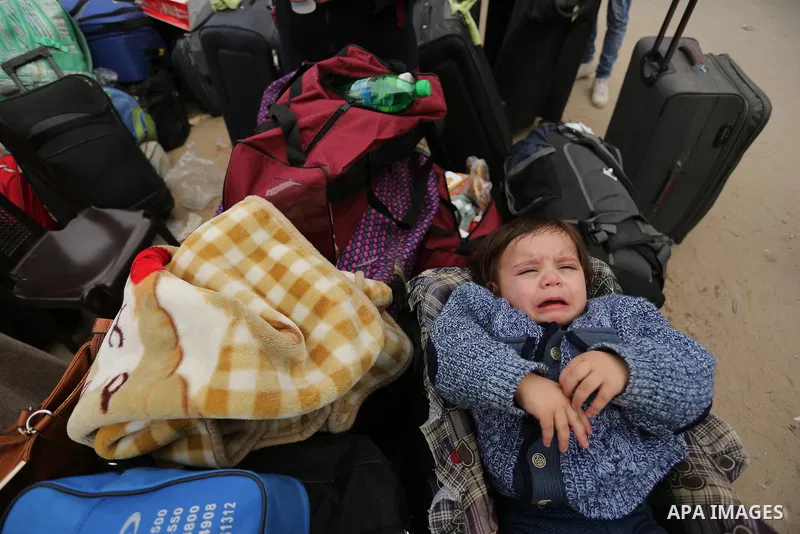 Palestinians wait for travel permits to cross into Egypt through the Rafah border crossing after it was opened by Egyptian authorities for humanitarian cases on the first time in 2018, in the southern Gaza Strip on Febru...