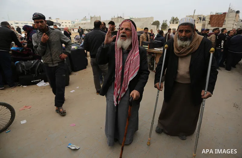 Palestinians wait for travel permits to cross into Egypt through the Rafah border crossing after it was opened by Egyptian authorities for humanitarian cases on the first time in 2018, in the southern Gaza Strip on Febru...