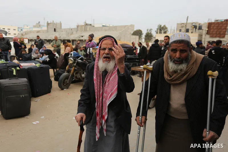 Palestinians wait for travel permits to cross into Egypt through the Rafah border crossing after it was opened by Egyptian authorities for humanitarian cases on the first time in 2018, in the southern Gaza Strip on Febru...