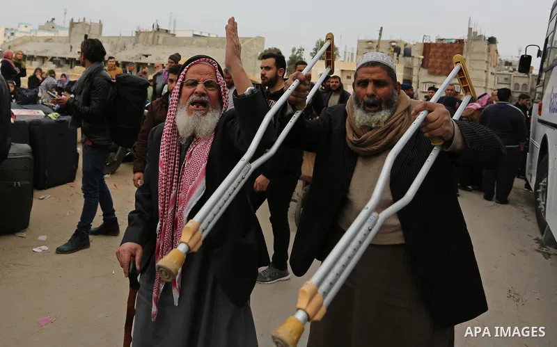 Palestinians wait for travel permits to cross into Egypt through the Rafah border crossing after it was opened by Egyptian authorities for humanitarian cases on the first time in 2018, in the southern Gaza Strip on Febru...