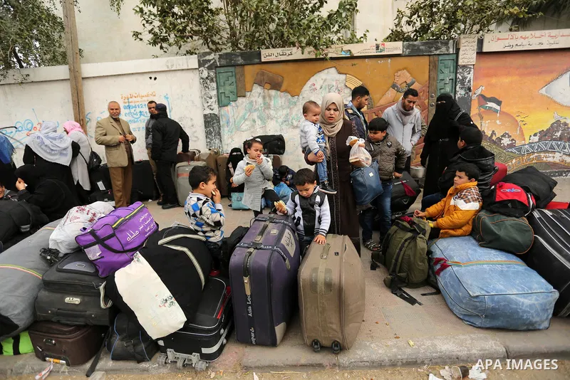Palestinians wait for travel permits to cross into Egypt through the Rafah border crossing after it was opened by Egyptian authorities for humanitarian cases on the first time in 2018, in the southern Gaza Strip on Febru...