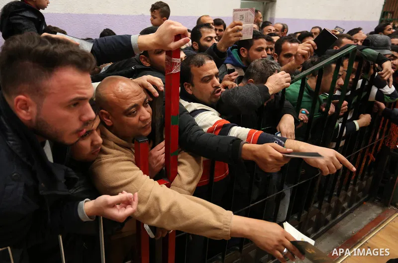 Palestinians wait for travel permits to cross into Egypt through the Rafah border crossing after it was opened by Egyptian authorities for humanitarian cases on the first time in 2018, in the southern Gaza Strip on Febru...