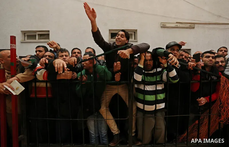 Palestinians wait for travel permits to cross into Egypt through the Rafah border crossing after it was opened by Egyptian authorities for humanitarian cases on the first time in 2018, in the southern Gaza Strip on Febru...