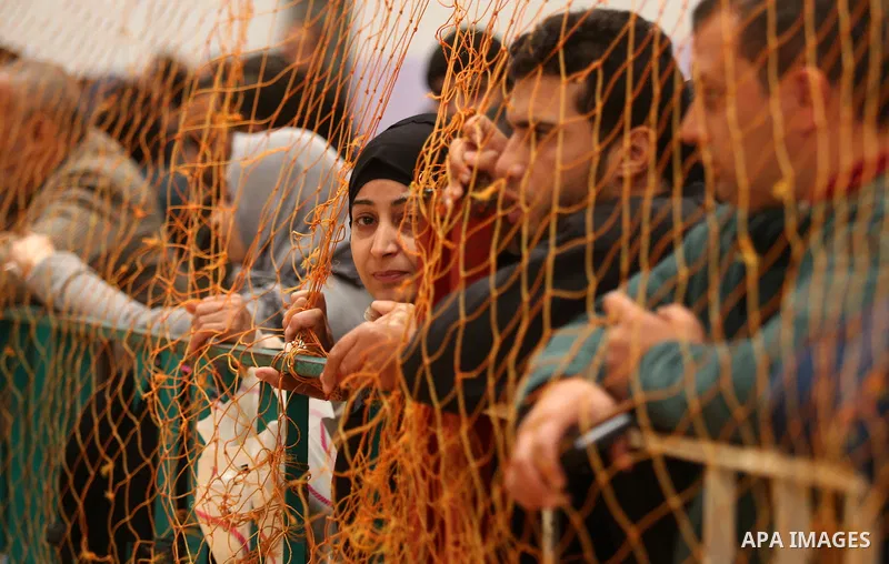 Palestinians wait for travel permits to cross into Egypt through the Rafah border crossing after it was opened by Egyptian authorities for humanitarian cases on the first time in 2018, in the southern Gaza Strip on Febru...