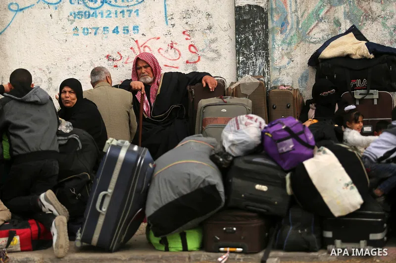 Palestinians wait for travel permits to cross into Egypt through the Rafah border crossing after it was opened by Egyptian authorities for humanitarian cases on the first time in 2018, in the southern Gaza Strip on Febru...