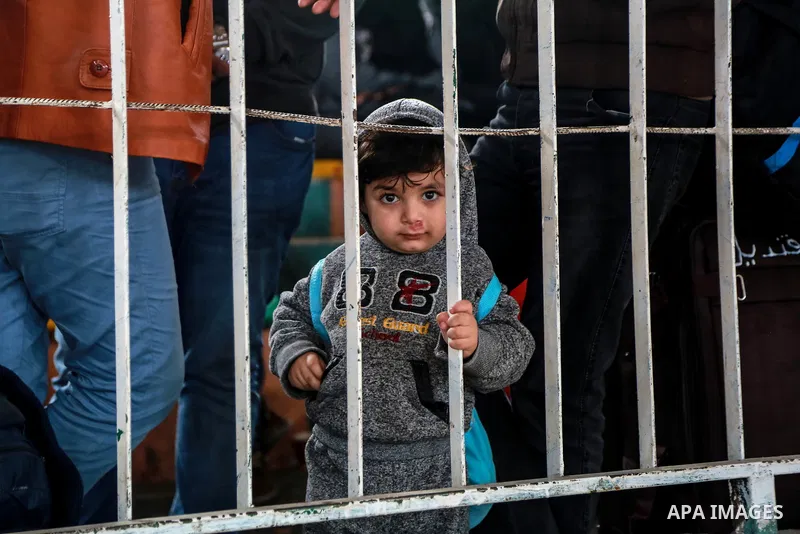 Palestinians wait for travel permits to cross into Egypt through the Rafah border crossing after it was opened by Egyptian authorities for humanitarian cases on the first time in 2018, in the southern Gaza Strip on Febru...