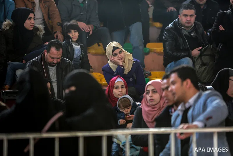 Palestinians wait for travel permits to cross into Egypt through the Rafah border crossing after it was opened by Egyptian authorities for humanitarian cases on the first time in 2018, in the southern Gaza Strip on Febru...