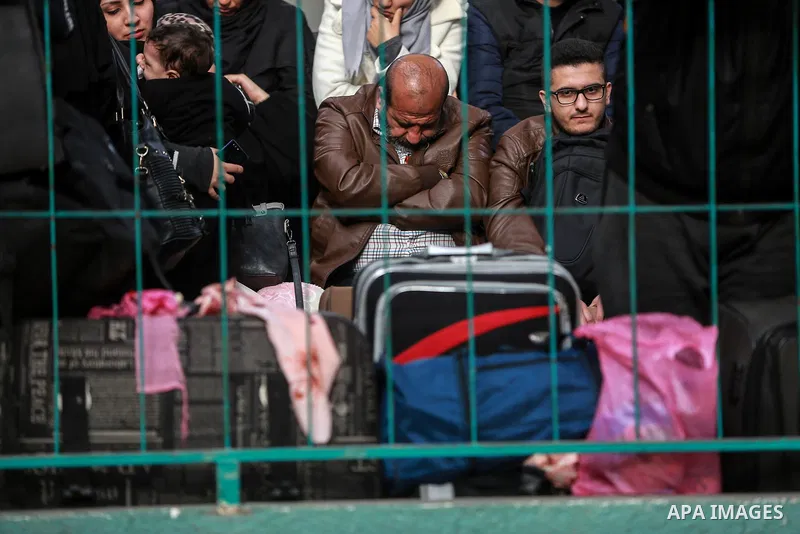 Palestinians wait for travel permits to cross into Egypt through the Rafah border crossing after it was opened by Egyptian authorities for humanitarian cases on the first time in 2018, in the southern Gaza Strip on Febru...