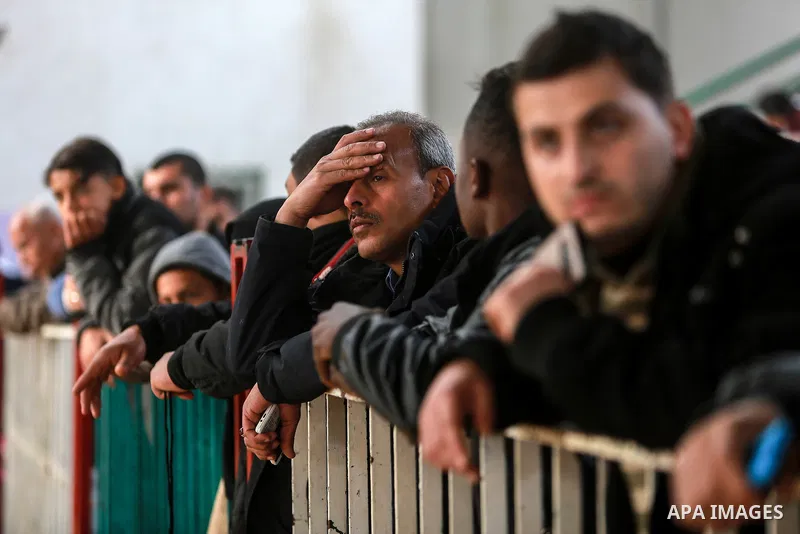 Palestinians wait for travel permits to cross into Egypt through the Rafah border crossing after it was opened by Egyptian authorities for humanitarian cases on the first time in 2018, in the southern Gaza Strip on Febru...