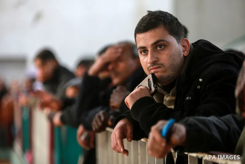 Palestinians wait for travel permits to cross into Egypt through the Rafah border crossing after it was opened by Egyptian authorities for humanitarian cases on the first time in 2018, in the southern Gaza Strip on Febru...