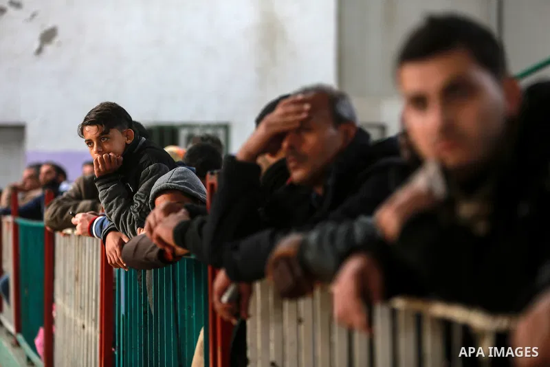 Palestinians wait for travel permits to cross into Egypt through the Rafah border crossing after it was opened by Egyptian authorities for humanitarian cases on the first time in 2018, in the southern Gaza Strip on Febru...