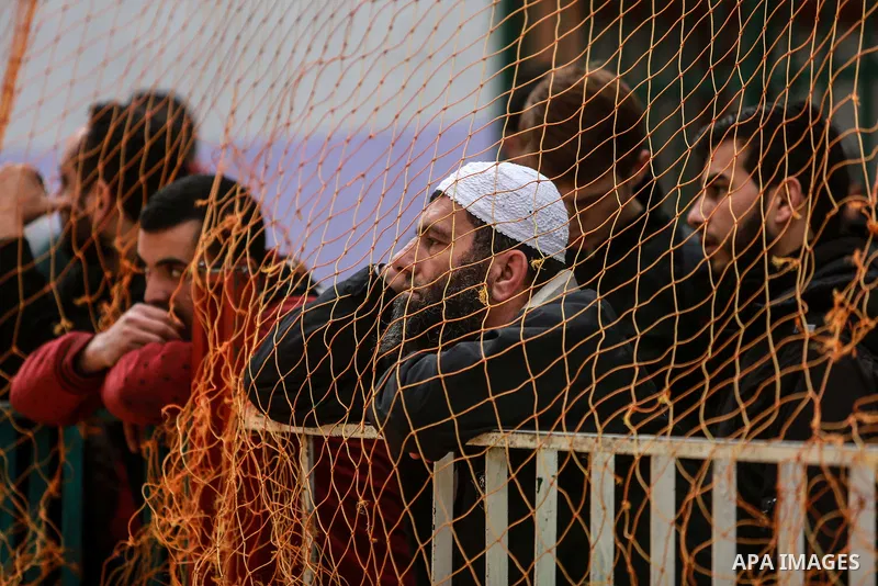 Palestinians wait for travel permits to cross into Egypt through the Rafah border crossing after it was opened by Egyptian authorities for humanitarian cases on the first time in 2018, in the southern Gaza Strip on Febru...