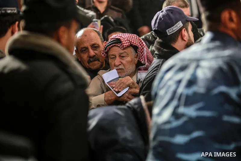 Palestinians wait for travel permits to cross into Egypt through the Rafah border crossing after it was opened by Egyptian authorities for humanitarian cases on the first time in 2018, in the southern Gaza Strip on Febru...