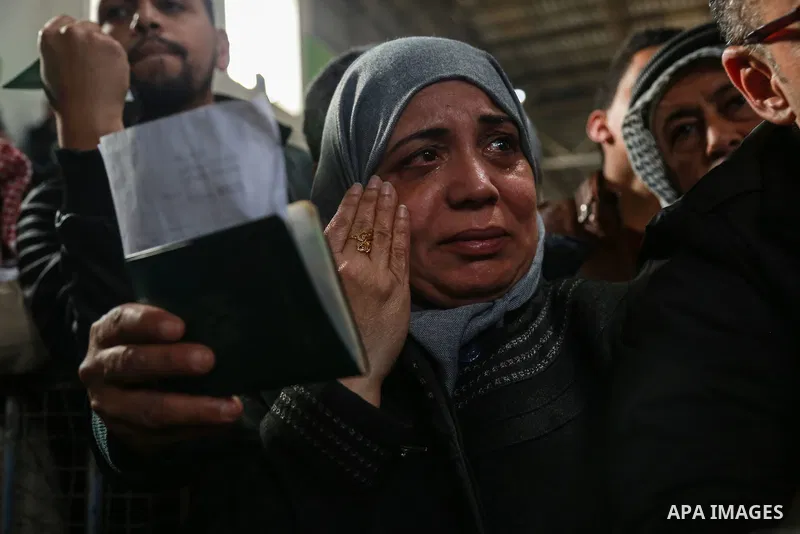 Palestinians wait for travel permits to cross into Egypt through the Rafah border crossing after it was opened by Egyptian authorities for humanitarian cases on the first time in 2018, in the southern Gaza Strip on Febru...