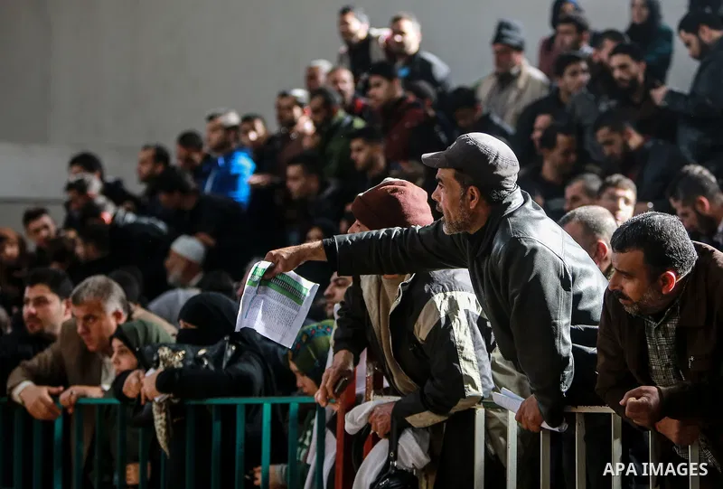 Palestinians wait for travel permits to cross into Egypt through the Rafah border crossing after it was opened by Egyptian authorities for humanitarian cases on the first time in 2018, in the southern Gaza Strip on Febru...