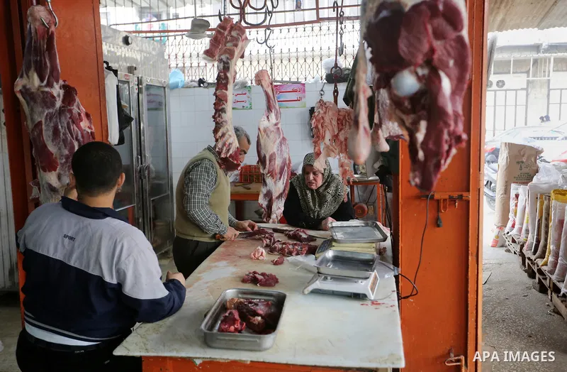 A Palestinian butcher cuts meat at a market in Gaza city on February 8, 2018. Last two days, chicken prices in Gaza strip soared to a record high, to reach to 5$ per 1 Kg. The ongoing economic crisis in the Gaza Strip co...