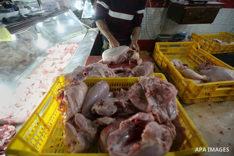 A Palestinian butcher cuts chicken meat at a market in Gaza city on February 8, 2018. Last two days, chicken prices in Gaza strip soared to a record high, to reach to 5$ per 1 Kg. The ongoing economic crisis in the Gaza...