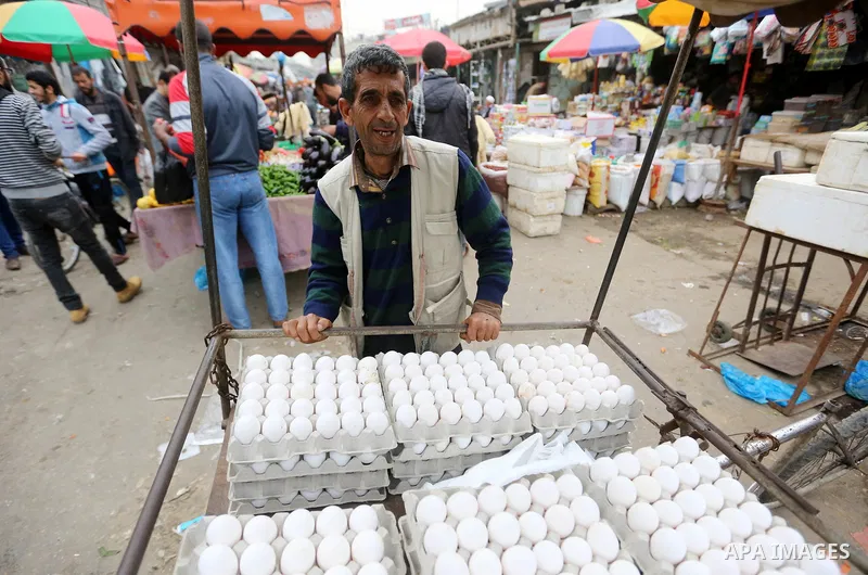 A Palestinian vendor sells eggs at a market in Gaza city on February 8, 2018. Last two days, chicken prices in Gaza strip soared to a record high, to reach to 5$ per 1 Kg. The ongoing economic crisis in the Gaza Strip co...