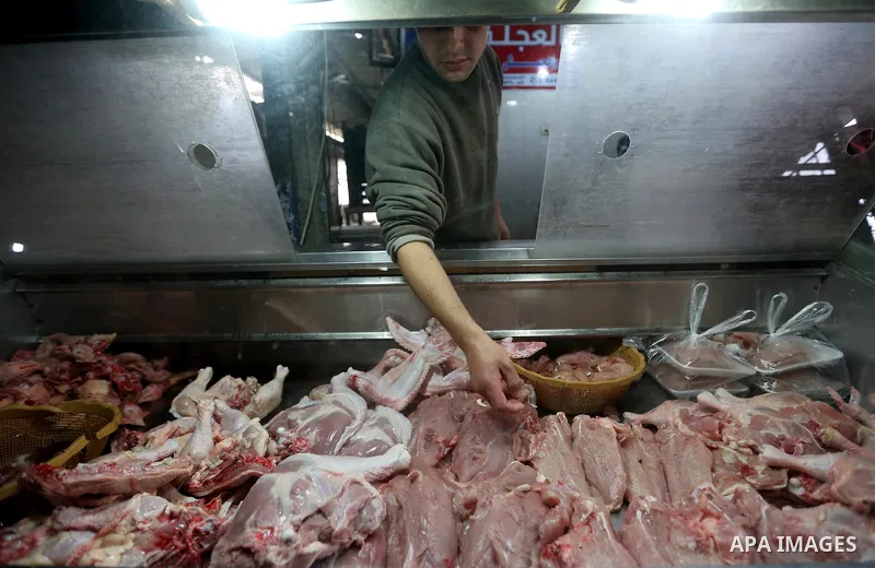 A Palestinian vendor sells chicken at a market in Gaza city on February 8, 2018. Last two days, chicken prices in Gaza strip soared to a record high, to reach to 5$ per 1 Kg. The ongoing economic crisis in the Gaza Strip...