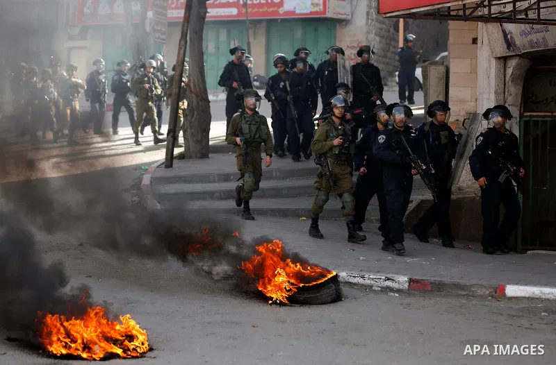 Israeli security froces take position during clashes with Palestinian protesters as demonstrations continue over US President Donald Trump's declaration of Jerusalem as Israel's capital, in the West Bank city of Hebron o...