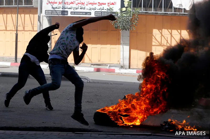 Palestinian protesters hurl stones during clashes with Israeli security forces as demonstrations continue over US President Donald Trump's declaration of Jerusalem as Israel's capital, in the West Bank city of Hebron on...