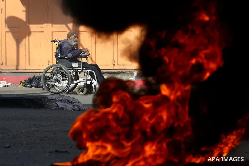 Palestinian protester on wheelchair take part during clashes with Palestinian protesters as demonstrations continue over US President Donald Trump's declaration of Jerusalem as Israel's capital, in the West Bank city of...