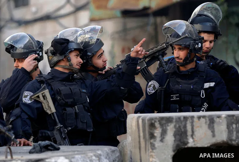 Israeli security froces take position during clashes with Palestinian protesters as demonstrations continue over US President Donald Trump's declaration of Jerusalem as Israel's capital, in the West Bank city of Hebron o...
