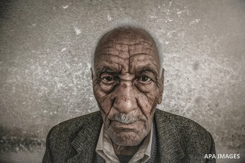 A portrait of an elderly man with wrinkled face and white hair. Photo by Sanad Ltefa