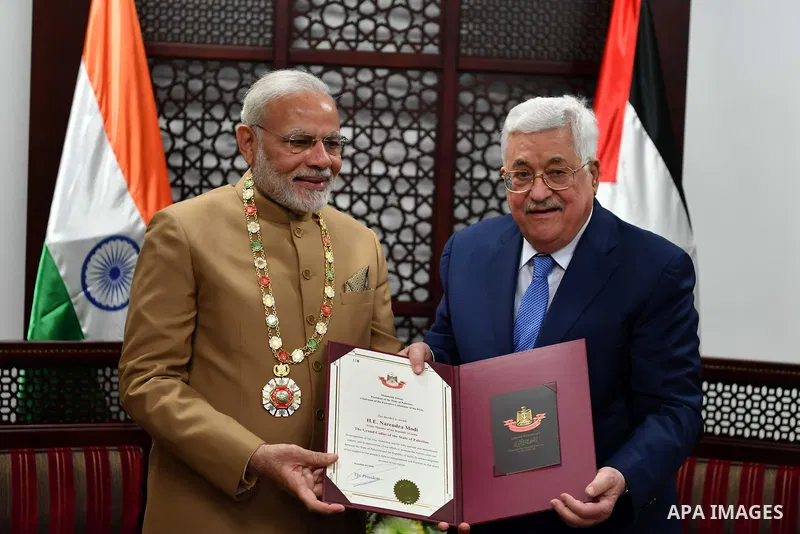 Palestinian President Mahmoud Abbas decorates Indian Prime Minister Narendra Modi with the Grand Collar of the State of Palestine medal, during the latter's visit to the Palestinian Authority headquarters in the West Ban...